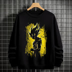 Black crewneck sweatshirt featuring Goku shadow silhouette with blue and pink neon aura and vertical Japanese text, flat lay on grey background.