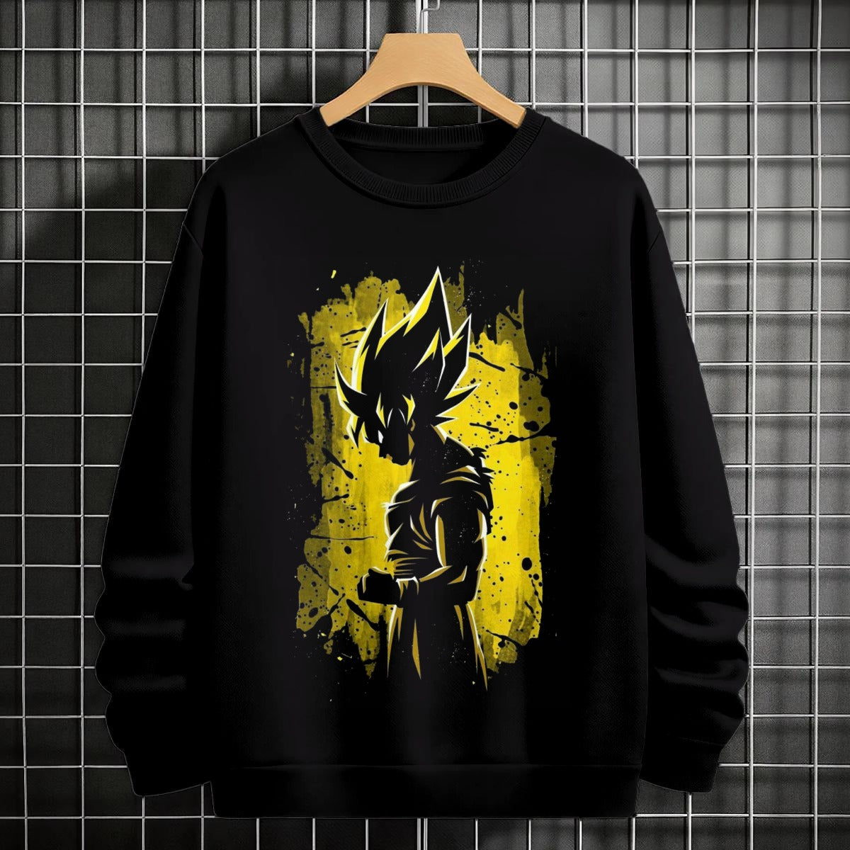 Black crewneck sweatshirt featuring Goku shadow silhouette with blue and pink neon aura and vertical Japanese text, flat lay on grey background.