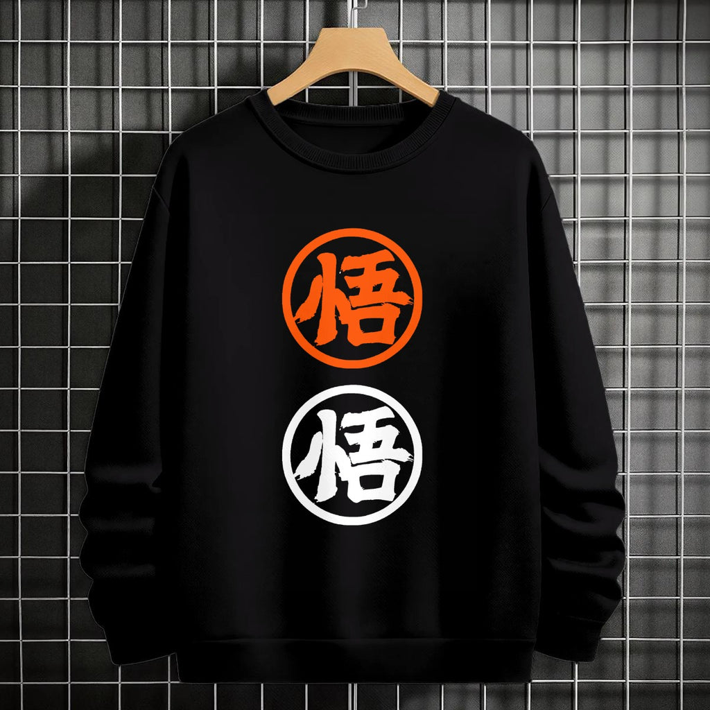 Black crewneck sweatshirt featuring two vertically stacked circular Dragon Ball Z 'Go' Kanji symbols (one orange, one white), flat lay on grey background.