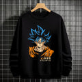 Black crewneck sweatshirt featuring Goku shadow silhouette with blue and pink neon aura and vertical Japanese text, flat lay on grey background.
