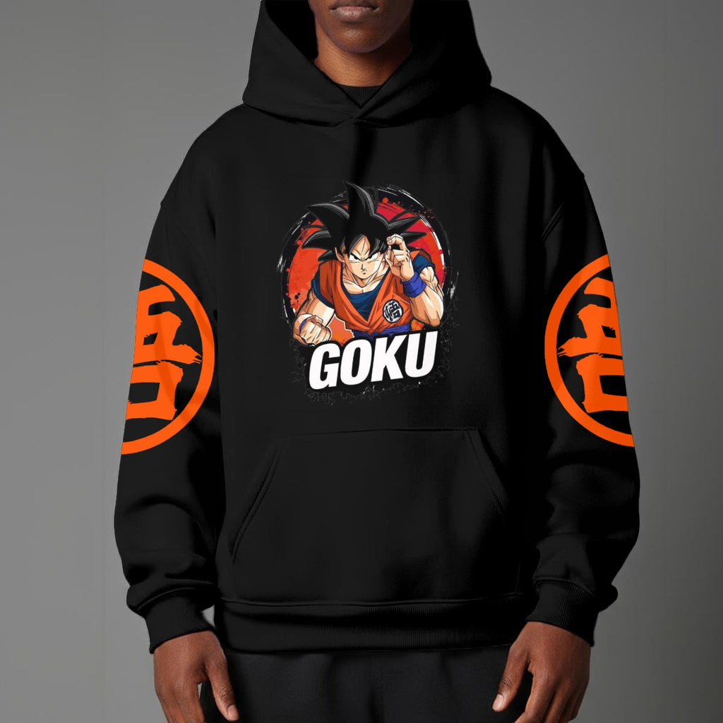 Black pullover hoodie with orange Goku silhouette on chest and vintage 1984 Dragon Ball graphics on sleeves, worn by model on grey background.