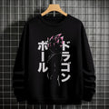 Black crewneck sweatshirt featuring Goku shadow silhouette with blue and pink neon aura and vertical Japanese text, flat lay on grey background.