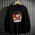 Black crewneck sweatshirt featuring Goku shadow silhouette with blue and pink neon aura and vertical Japanese text, flat lay on grey background.