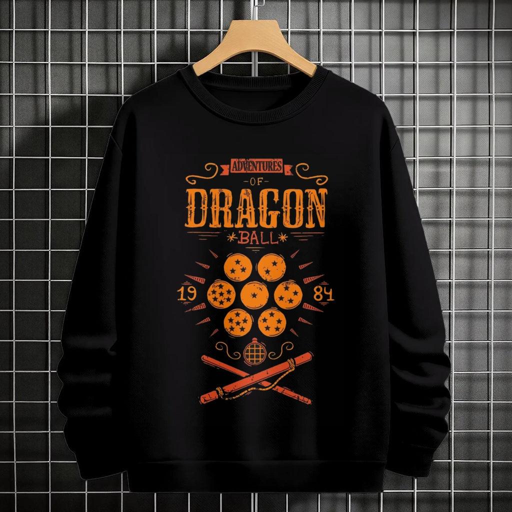 Black crewneck sweatshirt featuring Goku shadow silhouette with blue and pink neon aura and vertical Japanese text, flat lay on grey background.