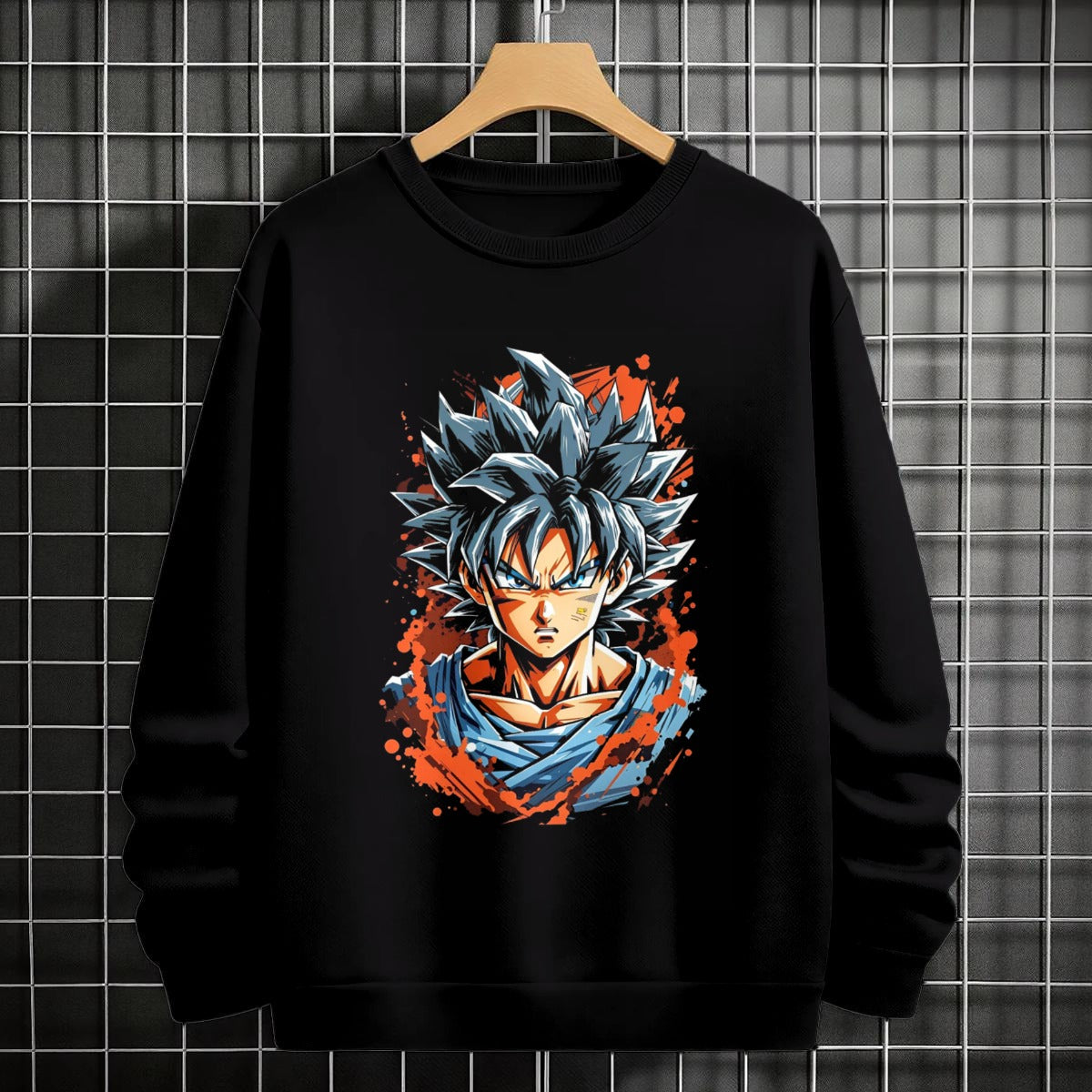 Black crewneck sweatshirt featuring Goku shadow silhouette with blue and pink neon aura and vertical Japanese text, flat lay on grey background.