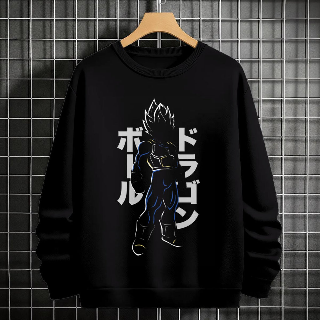 Black crewneck sweatshirt featuring Goku shadow silhouette with blue and pink neon aura and vertical Japanese text, flat lay on grey background.