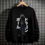 Black crewneck sweatshirt featuring Goku shadow silhouette with blue and pink neon aura and vertical Japanese text, flat lay on grey background.