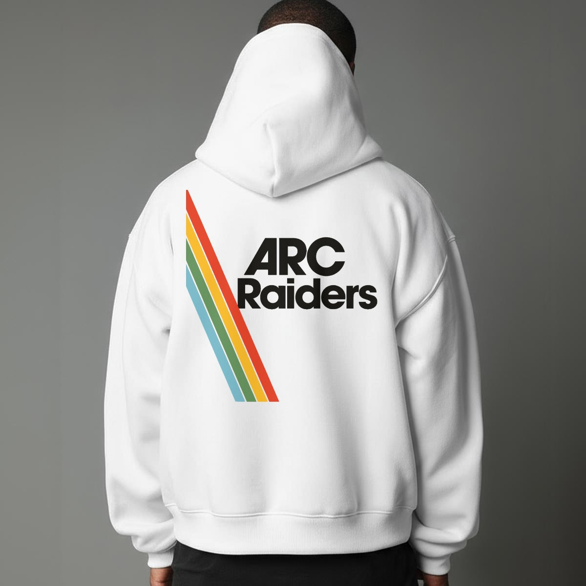 Person wearing a white hoodie with 'ARC Raiders' text and rainbow stripes on the back against a gray background