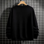 "Black crewneck sweatshirt featuring Goku shadow silhouette with blue and pink neon aura and vertical Japanese text, flat lay on grey background."