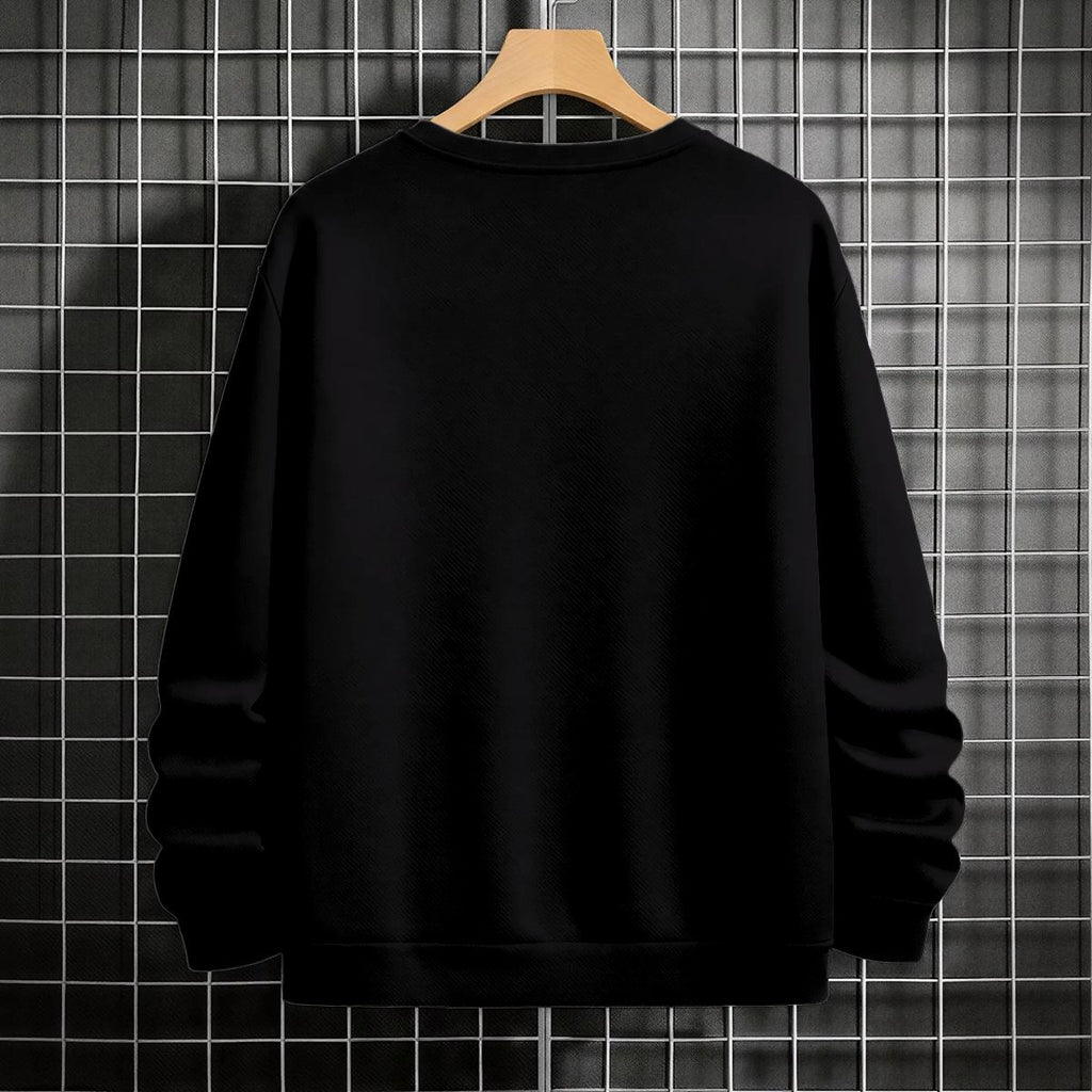 Black crewneck sweatshirt featuring Goku shadow silhouette with blue and pink neon aura and vertical Japanese text, flat lay on grey background.