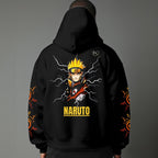 Black pullover hoodie featuring Naruto Uzumaki portrait on chest and vertical orange Japanese Kanji text on sleeves, worn by model on grey background.