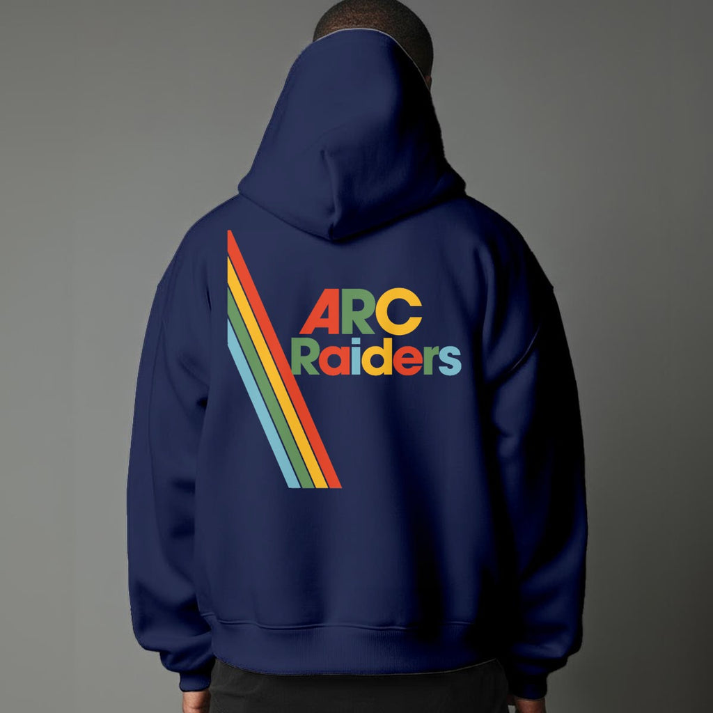 Person wearing a blue hoodie with 'ARC Raiders' text and rainbow design on the back against a gray background