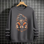 Black crewneck sweatshirt featuring Goku shadow silhouette with blue and pink neon aura and vertical Japanese text, flat lay on grey background.