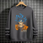 Black crewneck sweatshirt featuring Goku shadow silhouette with blue and pink neon aura and vertical Japanese text, flat lay on grey background.