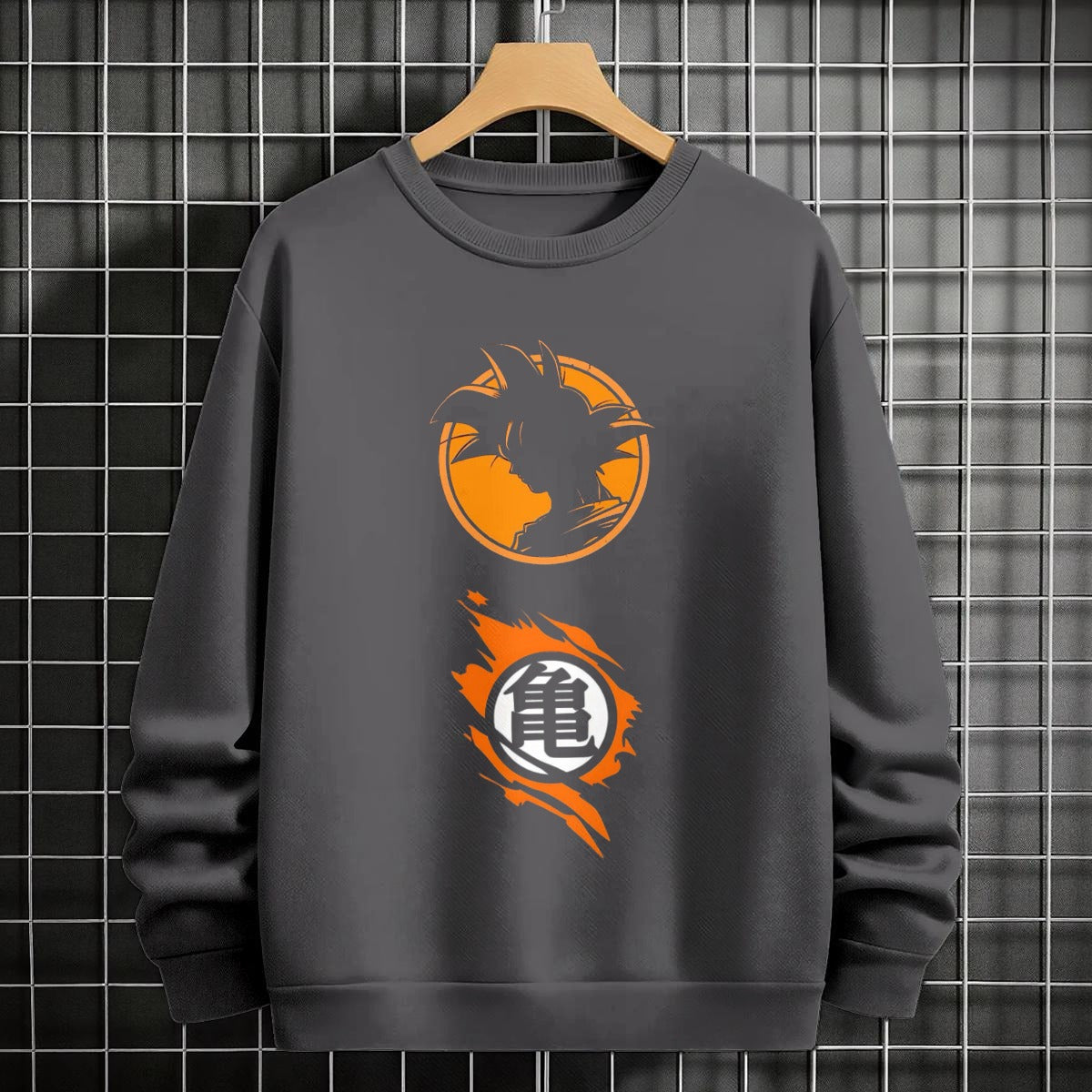 Black crewneck sweatshirt featuring Goku shadow silhouette with blue and pink neon aura and vertical Japanese text, flat lay on grey background.