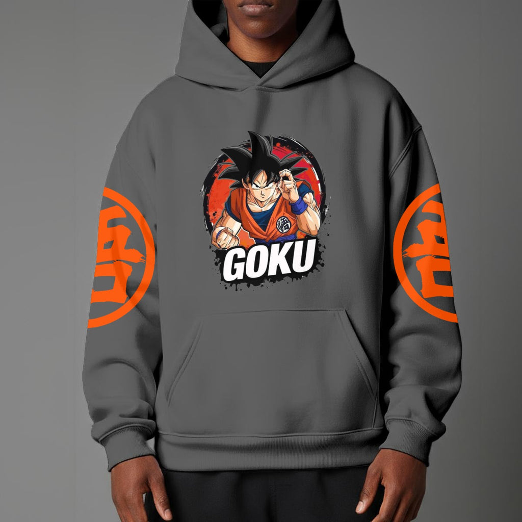Black pullover hoodie with orange Goku silhouette on chest and vintage 1984 Dragon Ball graphics on sleeves, worn by model on grey background.