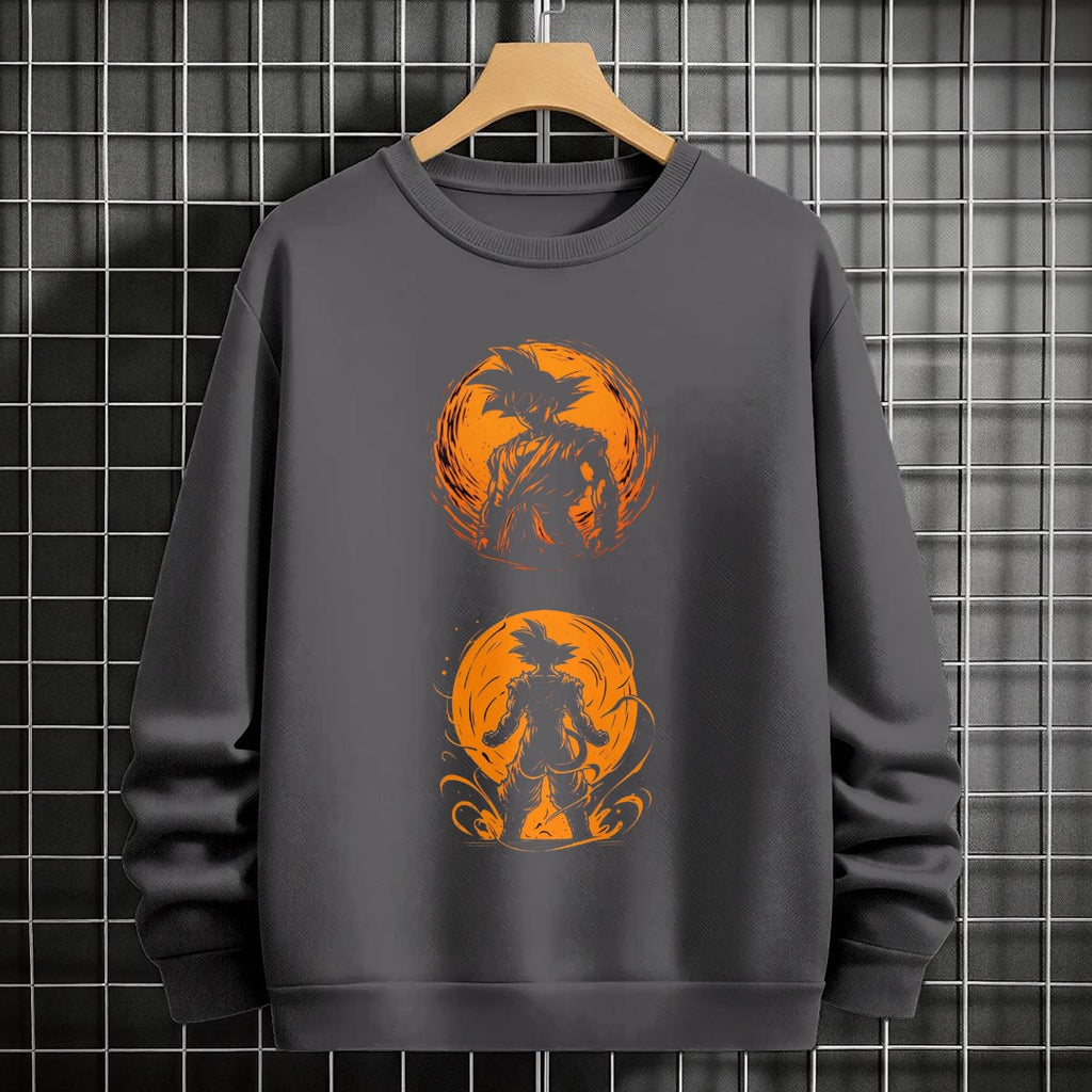 Black crewneck sweatshirt featuring Goku shadow silhouette with blue and pink neon aura and vertical Japanese text, flat lay on grey background.