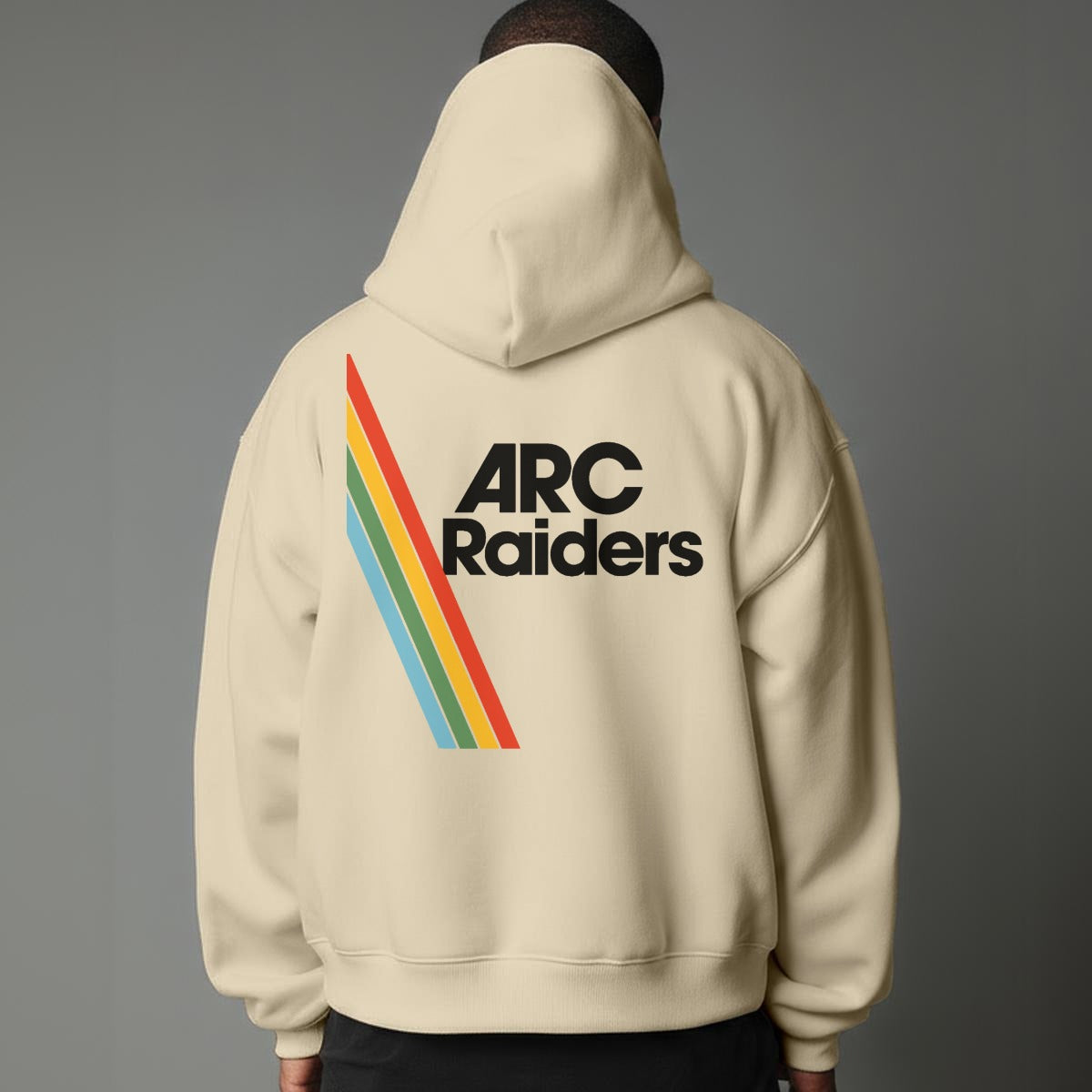 Beige hoodie with 'ARC Raiders' text and rainbow stripes on the back against a gray background