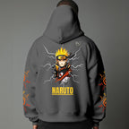 Black pullover hoodie featuring Naruto Uzumaki portrait on chest and vertical orange Japanese Kanji text on sleeves, worn by model on grey background.
