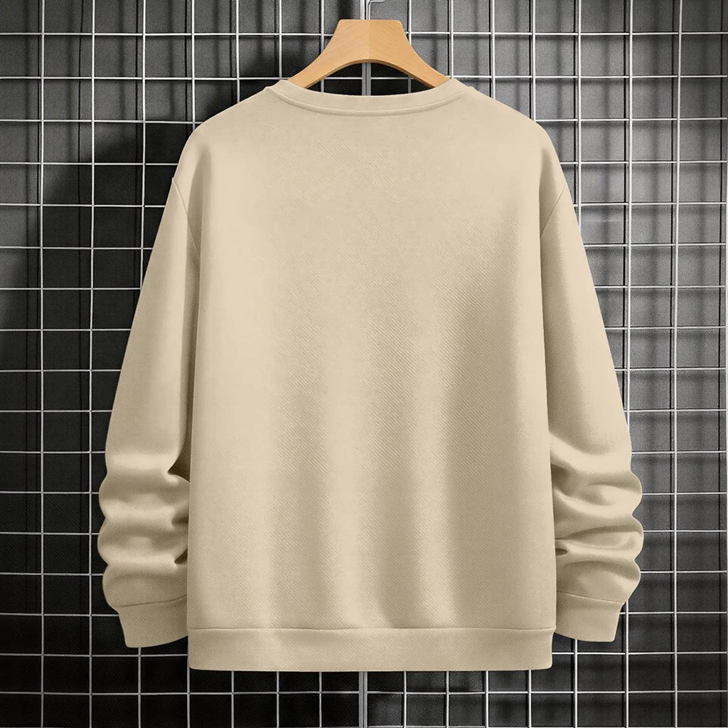 Beige sweatshirt on a wooden hanger against a grid-patterned wall.