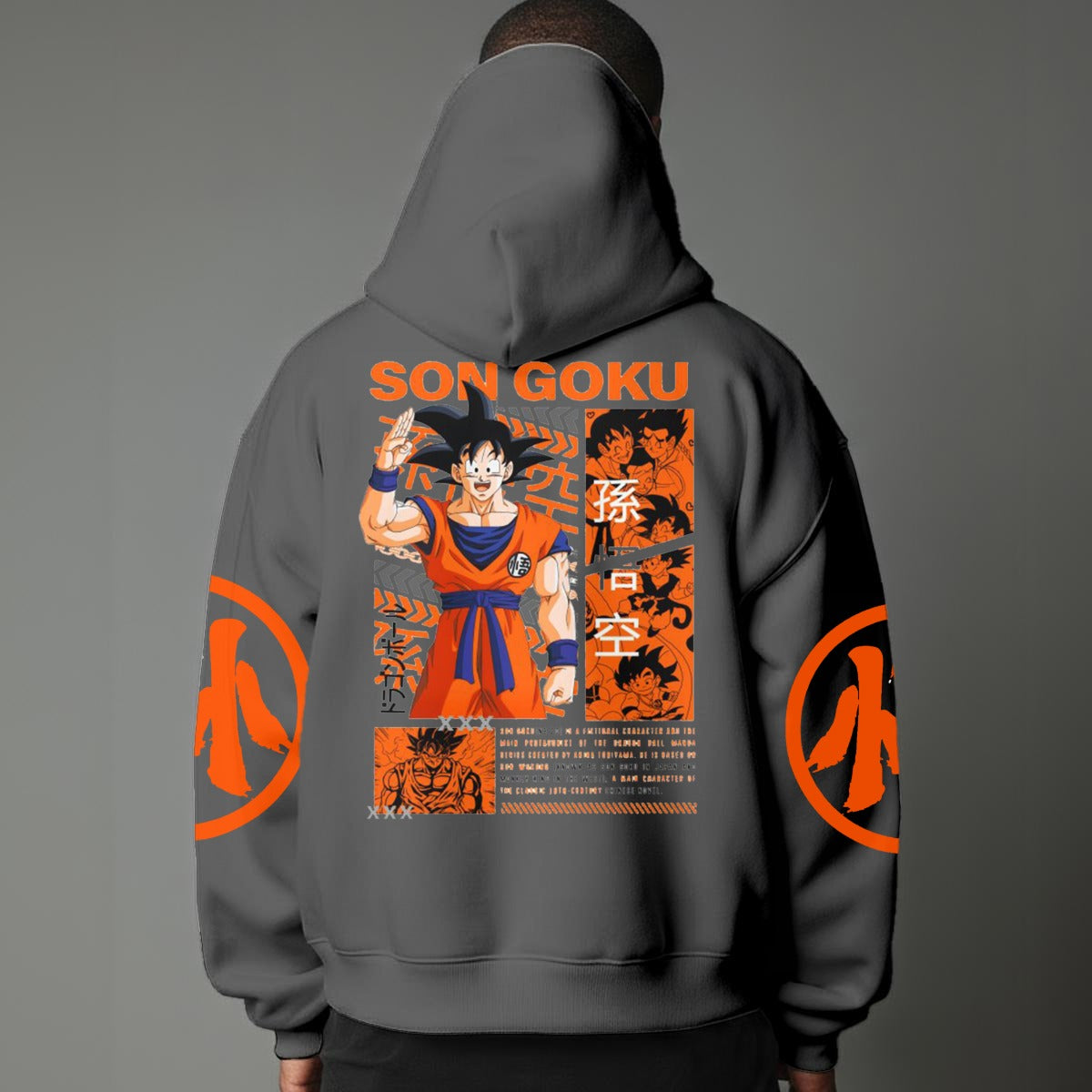Black pullover hoodie with orange Goku silhouette on chest and vintage 1984 Dragon Ball graphics on sleeves, worn by model on grey background.