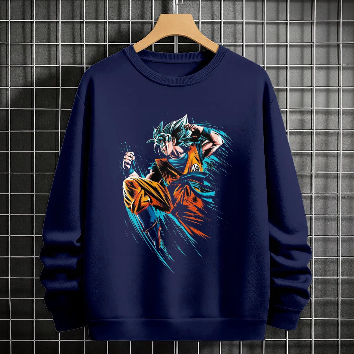 Black crewneck sweatshirt featuring Goku shadow silhouette with blue and pink neon aura and vertical Japanese text, flat lay on grey background.