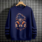 Black crewneck sweatshirt featuring Goku shadow silhouette with blue and pink neon aura and vertical Japanese text, flat lay on grey background.