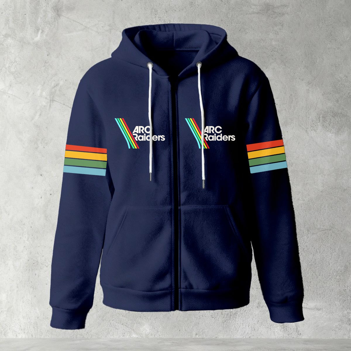 Black zip-up hoodie featuring ARC Raiders logo on chest and retro red, yellow, green, and blue stripes on sleeves, flat lay on grey background.