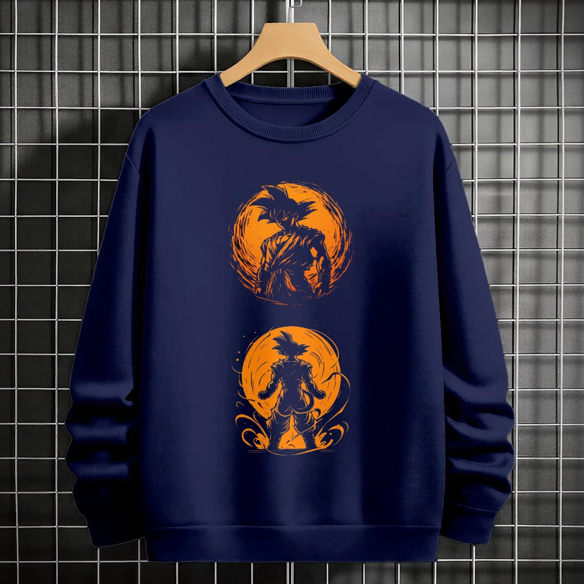 Black crewneck sweatshirt featuring Goku shadow silhouette with blue and pink neon aura and vertical Japanese text, flat lay on grey background.