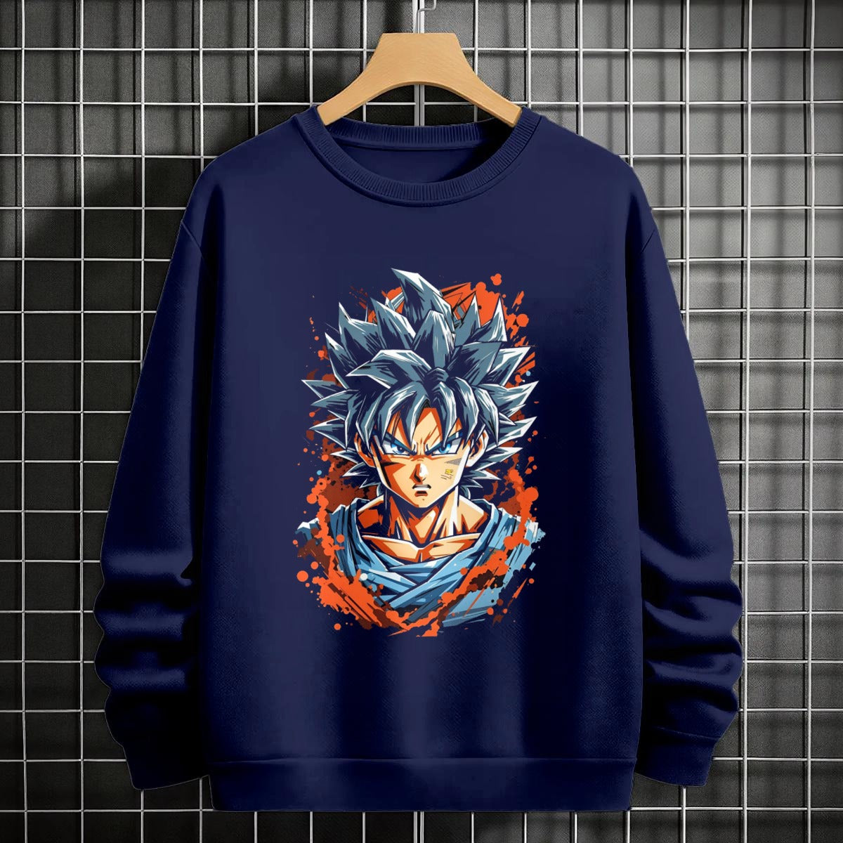 Black crewneck sweatshirt featuring Goku shadow silhouette with blue and pink neon aura and vertical Japanese text, flat lay on grey background.