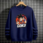 Black crewneck sweatshirt featuring Goku shadow silhouette with blue and pink neon aura and vertical Japanese text, flat lay on grey background.