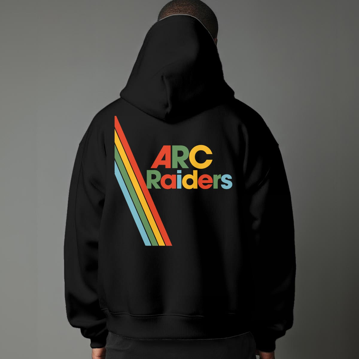 Black hoodie with 'ARC Raiders' colorful text design on the back against a gray background
