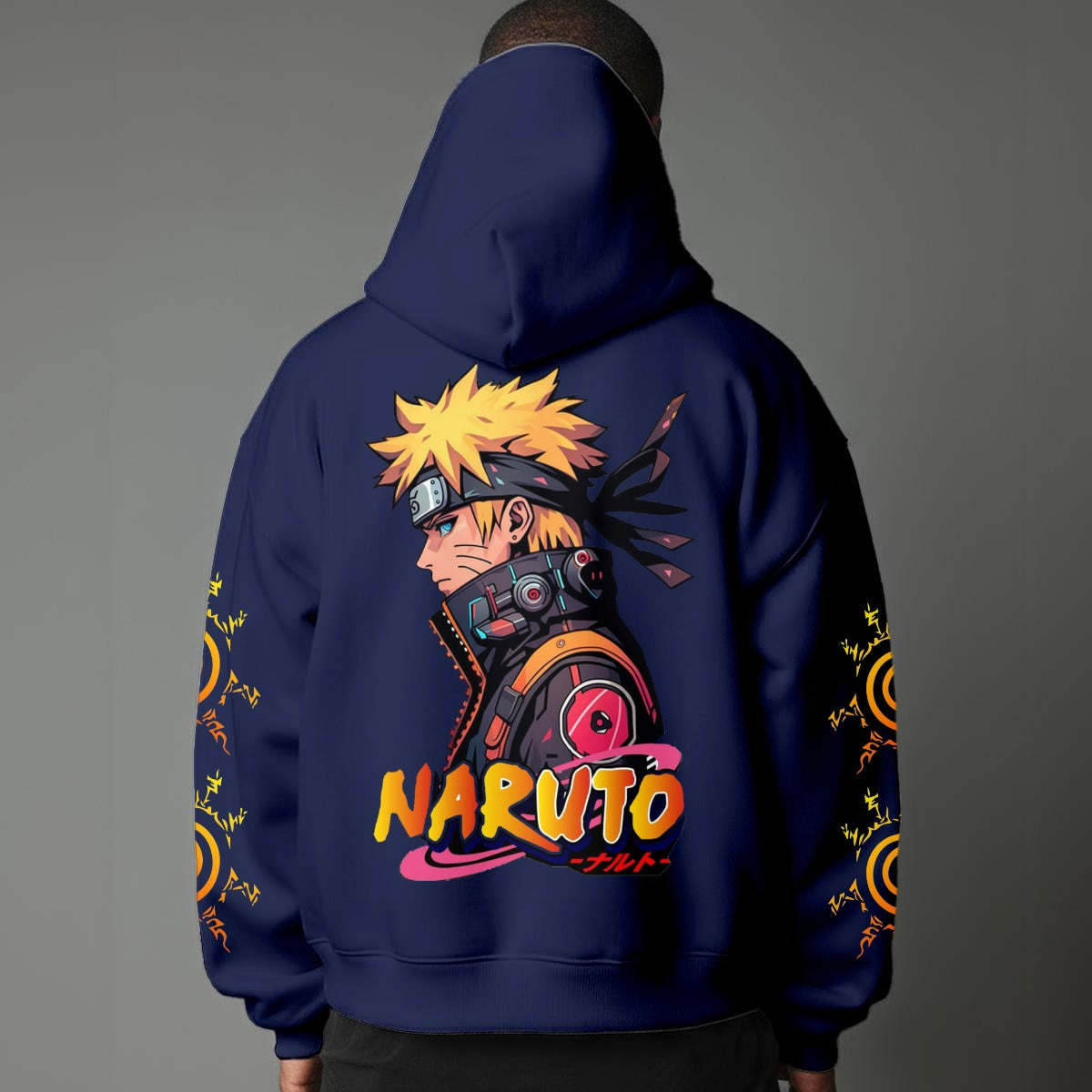 Black pullover hoodie featuring Naruto Uzumaki portrait on chest and vertical orange Japanese Kanji text on sleeves, worn by model on grey background.