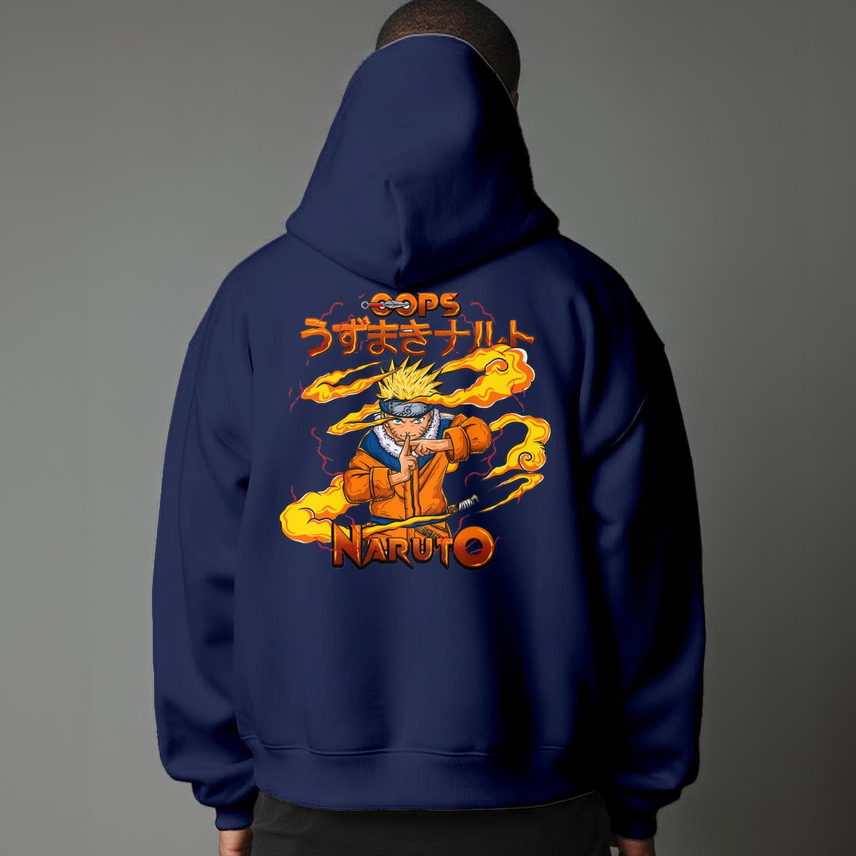 Black pullover hoodie featuring Naruto Uzumaki portrait on chest and vertical orange Japanese Kanji text on sleeves, worn by model on grey background.