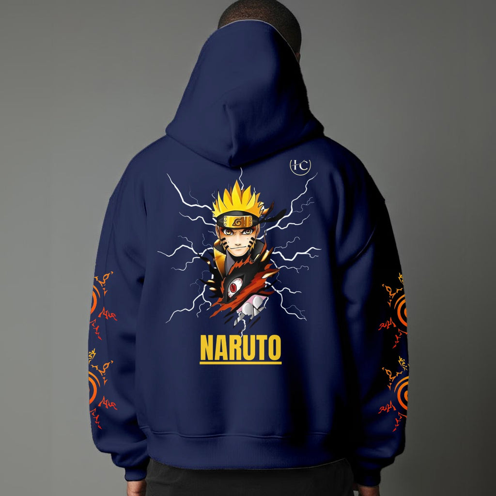 Black pullover hoodie featuring Naruto Uzumaki portrait on chest and vertical orange Japanese Kanji text on sleeves, worn by model on grey background.