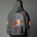 Black pullover hoodie with orange Goku silhouette on chest and vintage 1984 Dragon Ball graphics on sleeves, worn by model on grey background.