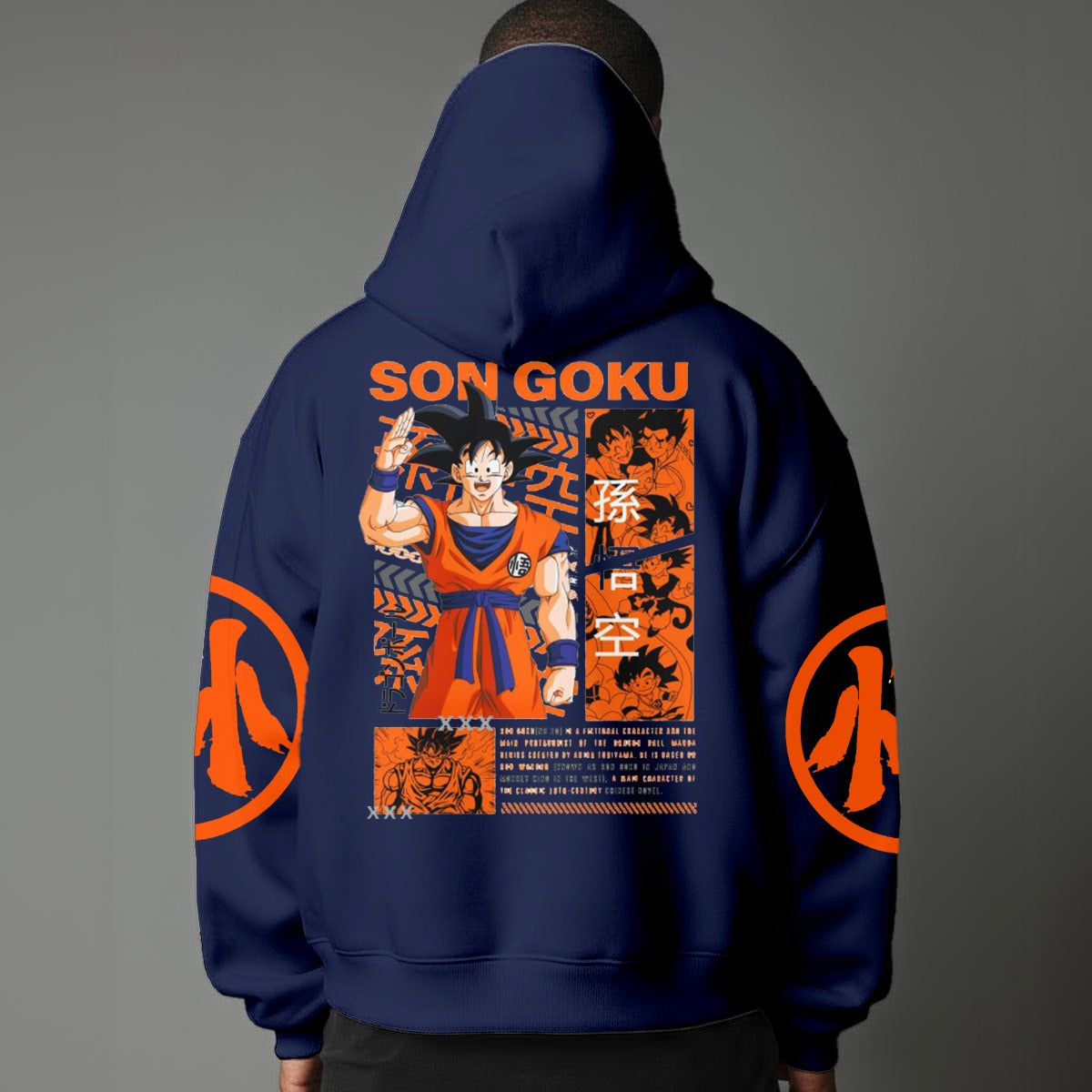 Black pullover hoodie with orange Goku silhouette on chest and vintage 1984 Dragon Ball graphics on sleeves, worn by model on grey background.