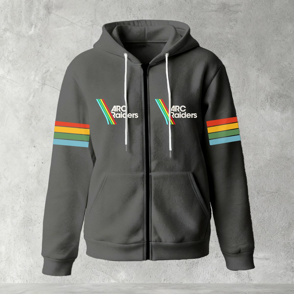Black zip-up hoodie featuring ARC Raiders logo on chest and retro red, yellow, green, and blue stripes on sleeves, flat lay on grey background.