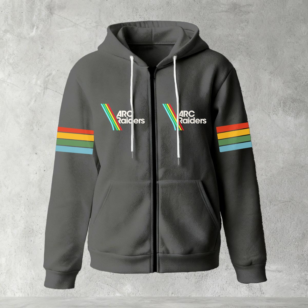 Black zip-up hoodie featuring ARC Raiders logo on chest and retro red, yellow, green, and blue stripes on sleeves, flat lay on grey background.