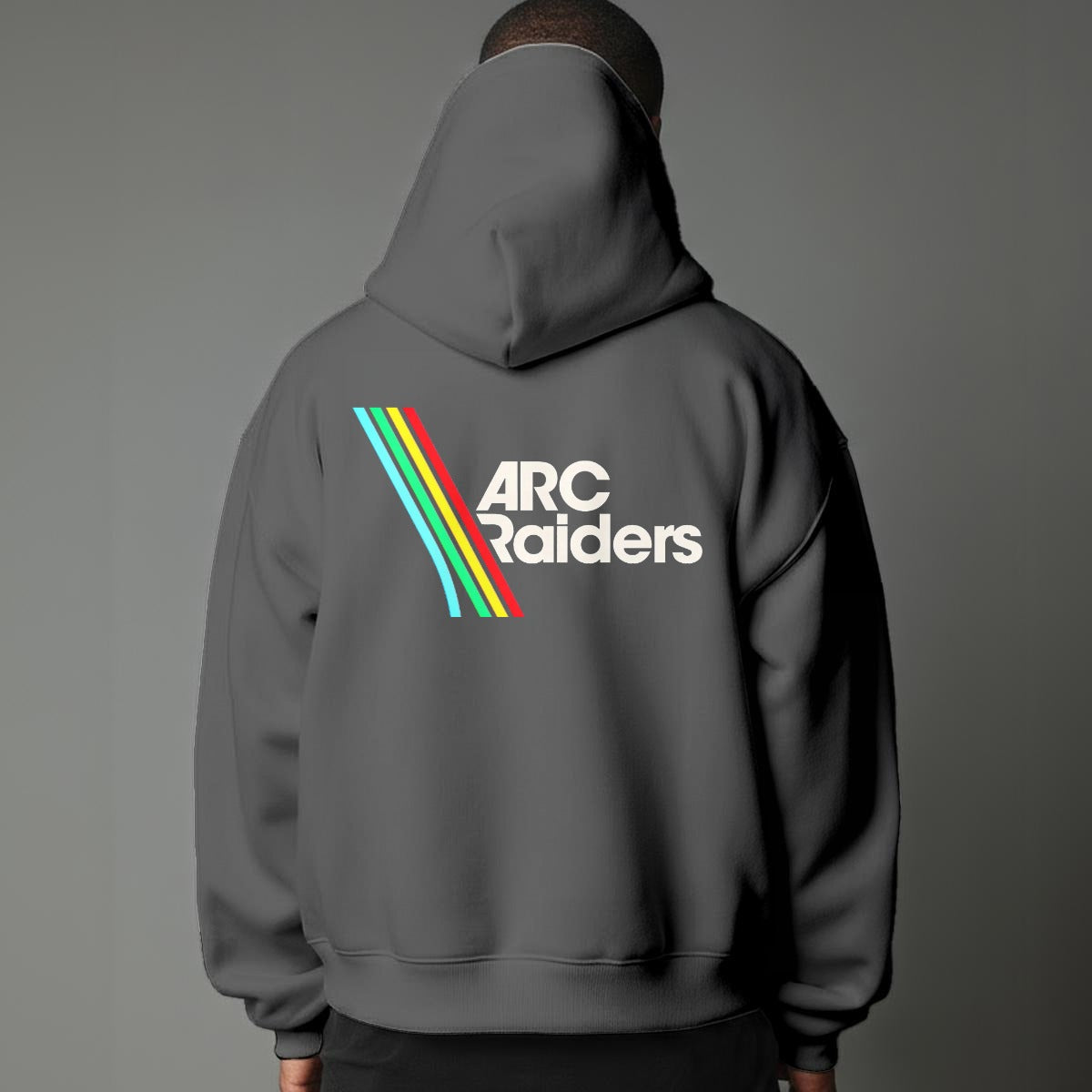 Person wearing a gray hoodie with 'ARC Raiders' logo on the back against a gray background