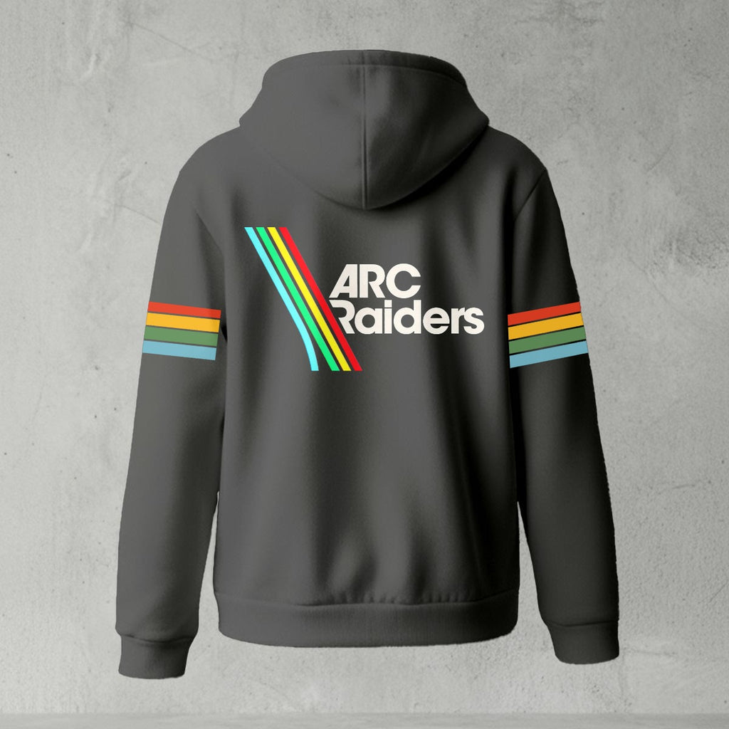 Black zip-up hoodie featuring ARC Raiders logo on chest and retro red, yellow, green, and blue stripes on sleeves, flat lay on grey background.