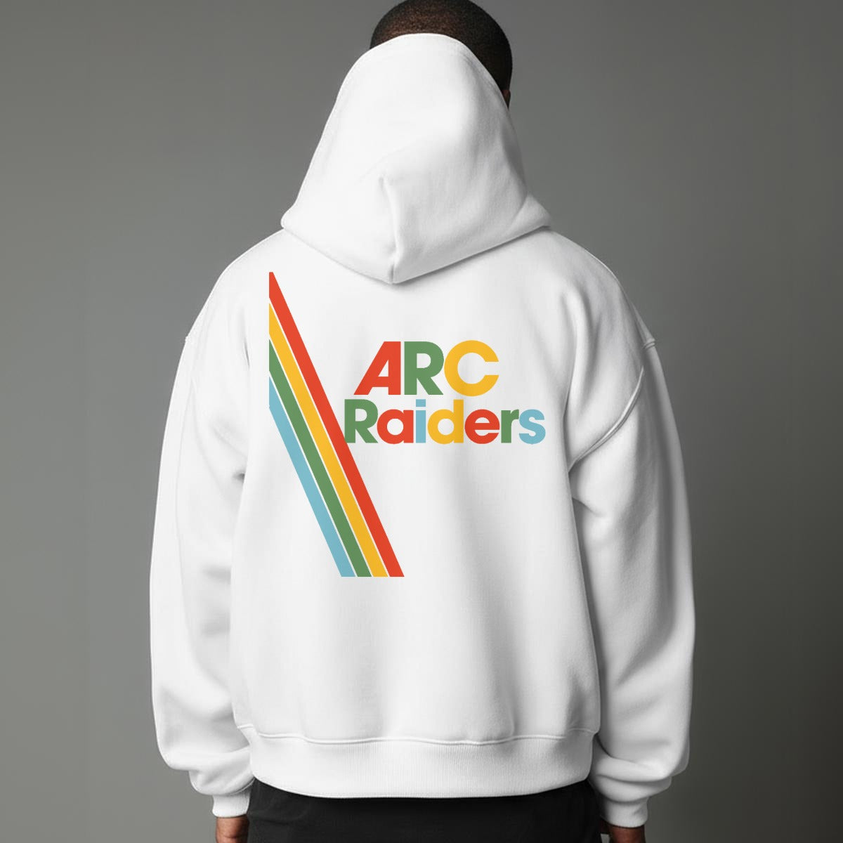 Person wearing a white hoodie with 'ARC Raiders' text and rainbow design on the back against a gray background